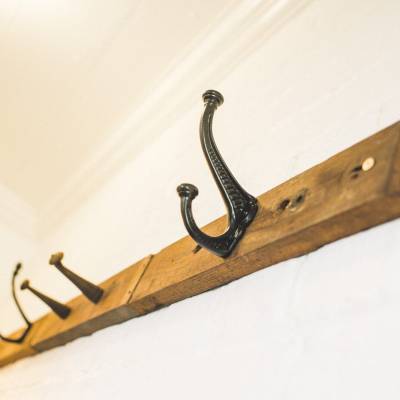 old fashioned hooks on the wall for hanging space in VoVo Suite Maitland Accommodation